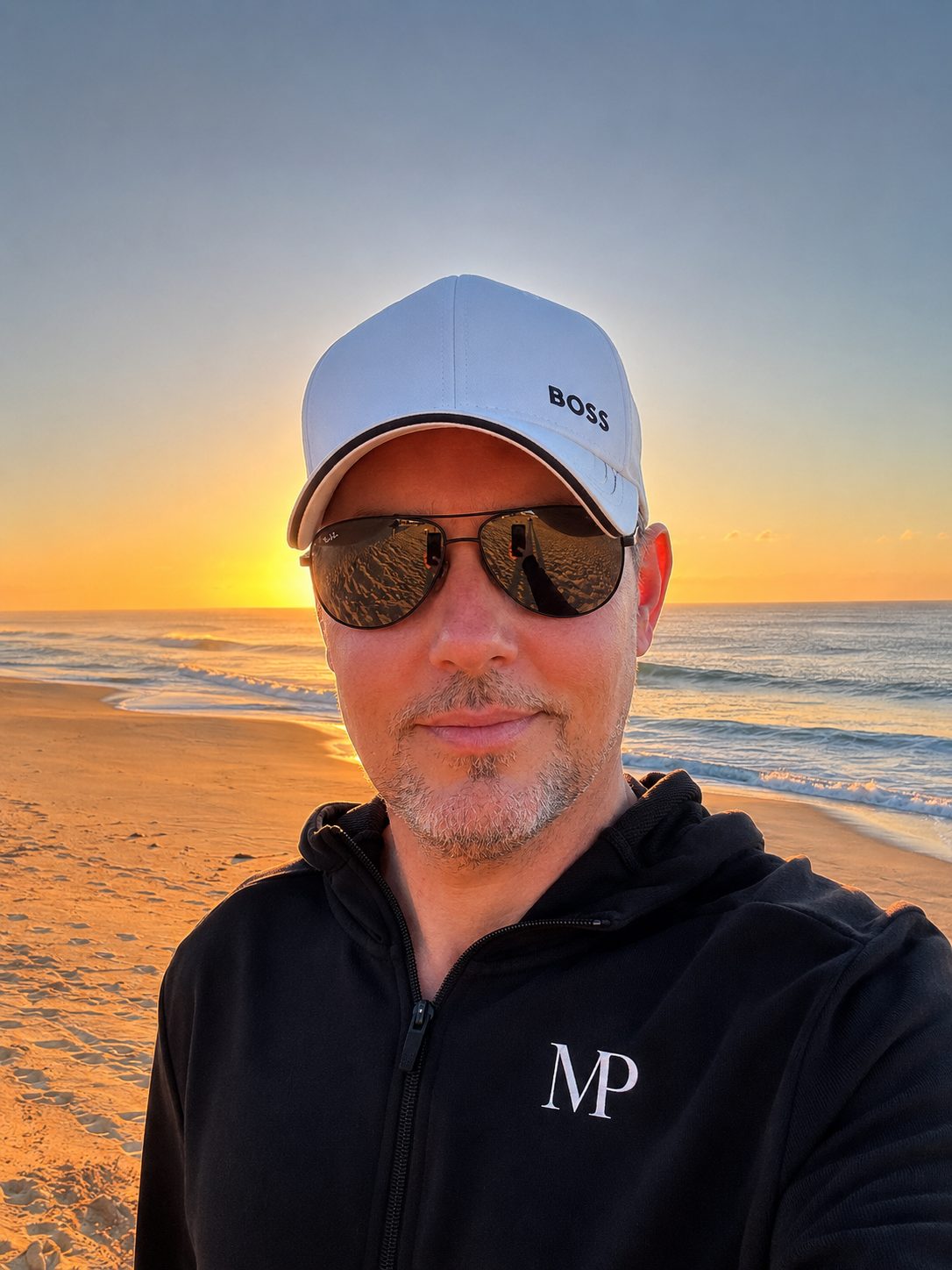 MY PERSPECTIVE — the founder on the beach at sunset in the MP hoodie